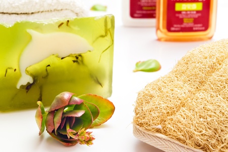 bath items including algae soap loofa towel and shapoo over whiteの写真素材