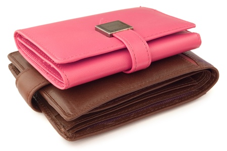 pink wallet on top of a brown walletの写真素材