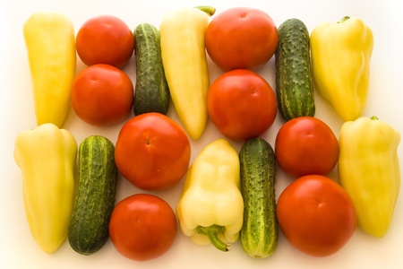 tomatoes, peppers and cucumbers over white backgroundの写真素材