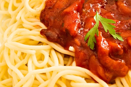Close-up of tomato sauce and parsley on spaghettiの写真素材