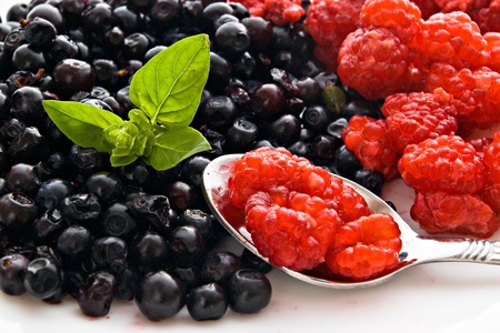 Strawberry basil and  raspberry on spoonの写真素材
