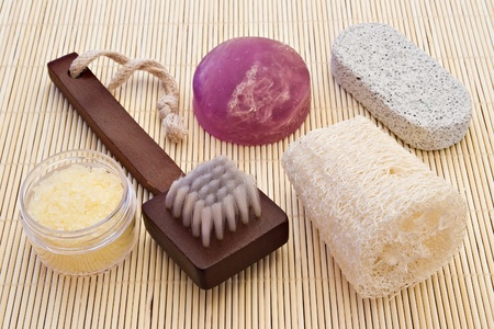 brush, loofah, sponge-stone, algae soap and sea-salt on bamboo boardの写真素材