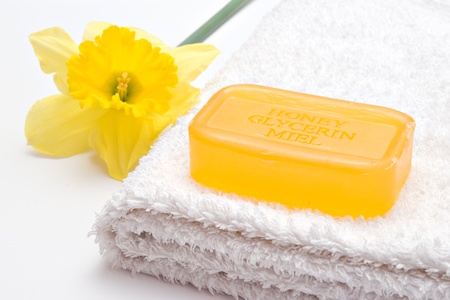 yellow flower and soap on the towelの写真素材