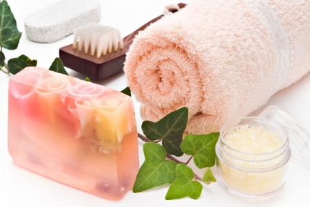 soap towel sea-salt brush and ivy branch arranged on white backgroundの写真素材