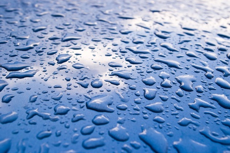sky reflected on surface with water-dropsの写真素材