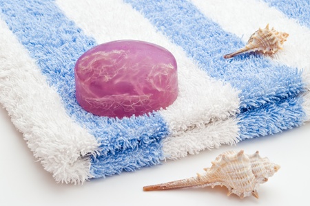 algae soap on white blue towel and sea-shellsの写真素材