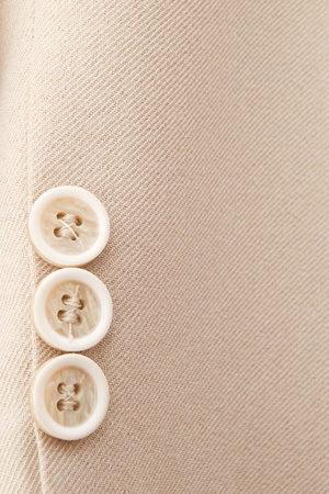 detail of elegant beige men's suit with three buttons