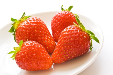 closeup of strawberries on white plateの写真素材