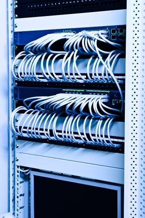 cables switches and patch on network rackの写真素材
