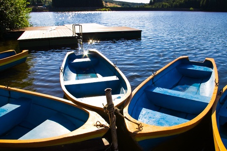boats lake and pontoon in morning lightの写真素材