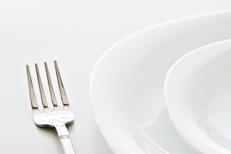 closeup of place setting with plates and fork