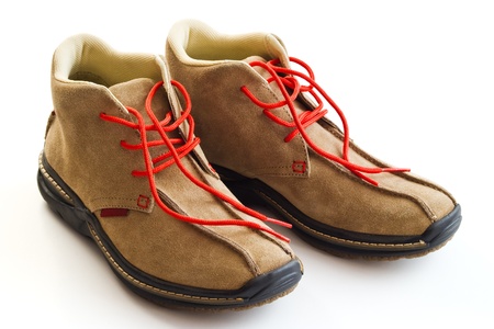 pair of winter shoes with red shoe lace isolated on whiteの写真素材