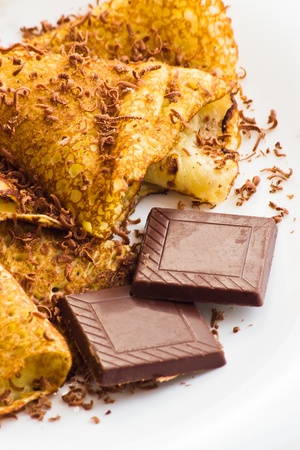 crepes with chocolate on white plateの写真素材