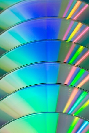 row of CDs with colorful reflectionの写真素材