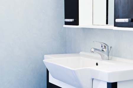 sink and mirror in blue bathroomの写真素材