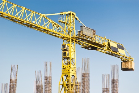 yellow construction crane on blue skyの写真素材