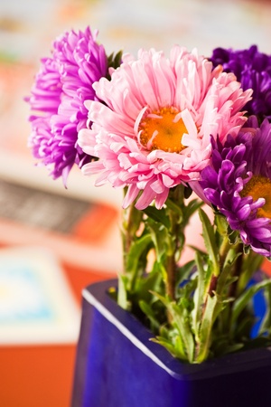 pink flowers in blue vase with shallow depth of fieldの写真素材
