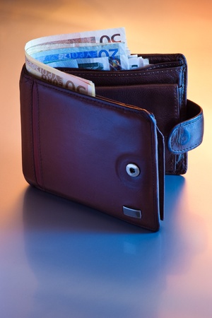 wallet with euro in blue and orange light