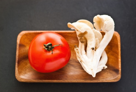 tomato and mushroom in wood trayの写真素材