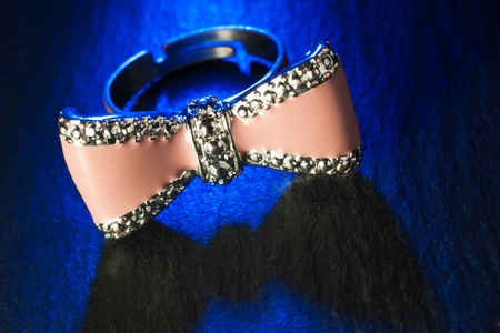 pink ring in blue light on black stoneの写真素材