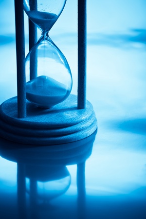 hour-glass with reflection in blue lightの写真素材