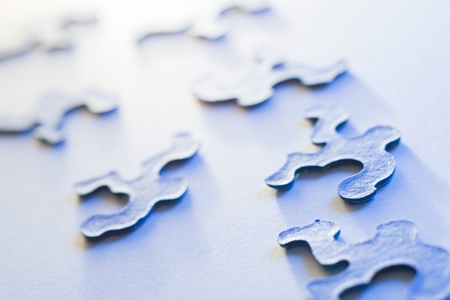 puzzle pieces with shallow depth of field in blue lightの写真素材