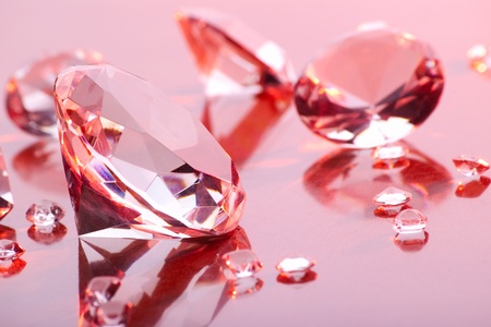 diamonds with different sizes in pink lightの写真素材