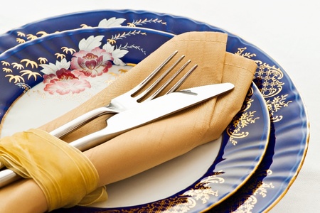fork and knife on fine blue porcelainの写真素材