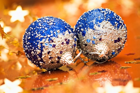 two blue christmas balls with shallow depth of field