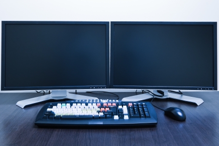 computer workstation with two LCD screens blue tonedの写真素材