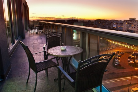table and chairs for city view at sunsetの写真素材