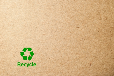 cardboard background with green recycle symbolの写真素材