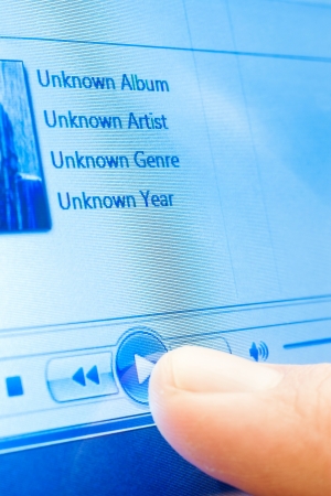 playing music on touchscreen device closeupの写真素材