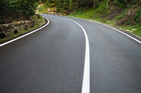 asphalt road curve with curve to the leftの写真素材
