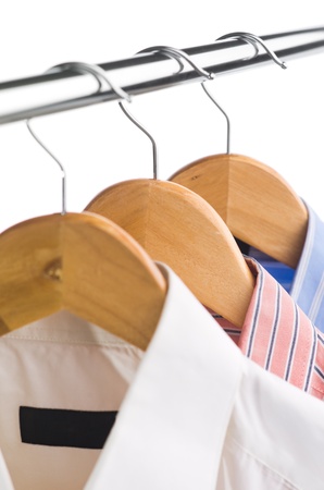 closeup of clothes hanger with shirts on whiteの写真素材
