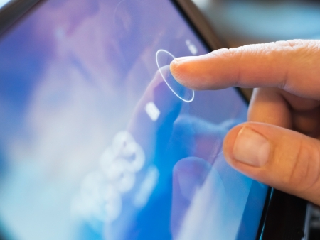 finger touching screen  on tablet-pc with shallow depth of fieldの写真素材