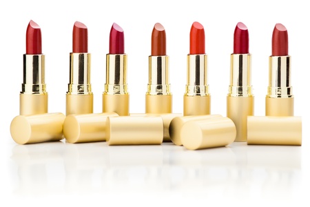 row of red lipsticks with refelction on whiteの写真素材