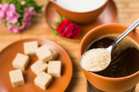 tablespoon with brown sugar on coffee cupの写真素材