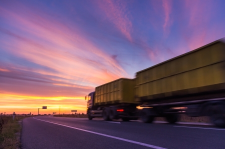 truck on road at sunsetの写真素材