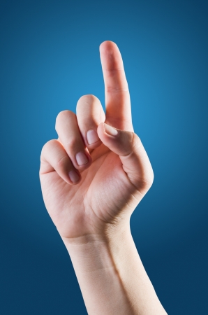 hand pointing, touching or pressing isolated with clipping path on blue backgroundの写真素材