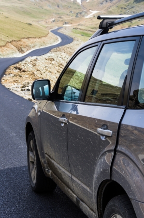 dirty suv on mountain roadの写真素材
