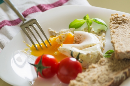 closeup of breakfast with eggs tomatoの写真素材