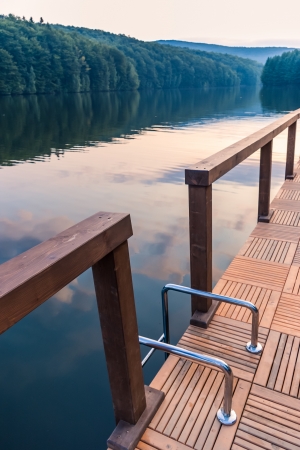 stairs railing on lake dock at eveningの写真素材