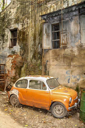Old orange car on the streets of Bangkok in Thailand.の写真素材