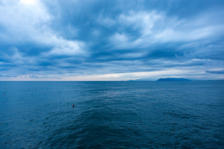 Heavy clowds above the dark blue Ligurian Sea, from the Lido di Camaiore beach in Italy.の写真素材