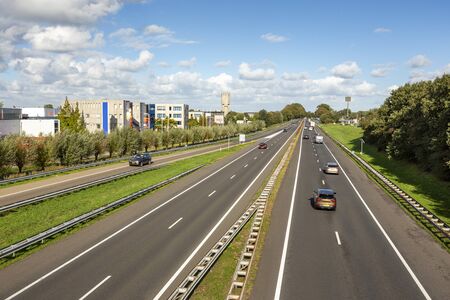 Cars driving on the A44 highway in the village of Sassenheim in the Netherlands.の写真素材