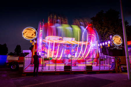 Blurry colourfull light lines from the fast moving fairground attraction at the Sassenheim town fair...
