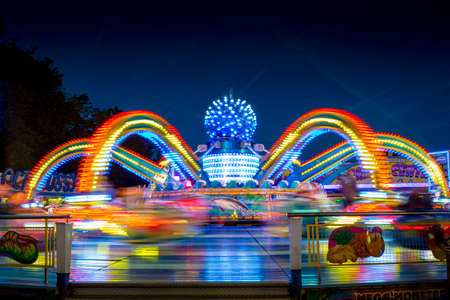 Blurry colourfull light lines from the fast moving fairground attraction at the Sassenheim town fair in the Netherlands.のeditorial素材