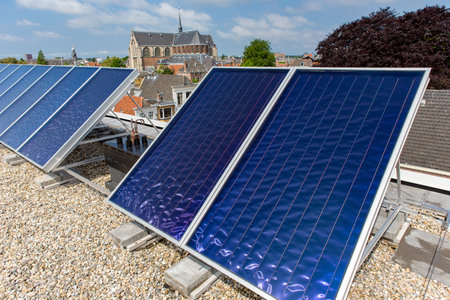 Solar panels on the roof in the South-Holland city of Leiden in the Netherlands. On the background the Hooglandse church.の写真素材