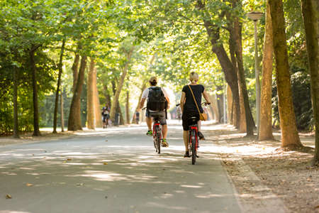 Man and woman biking in the Vondelpark in Amsterdam, Netherland.の写真素材